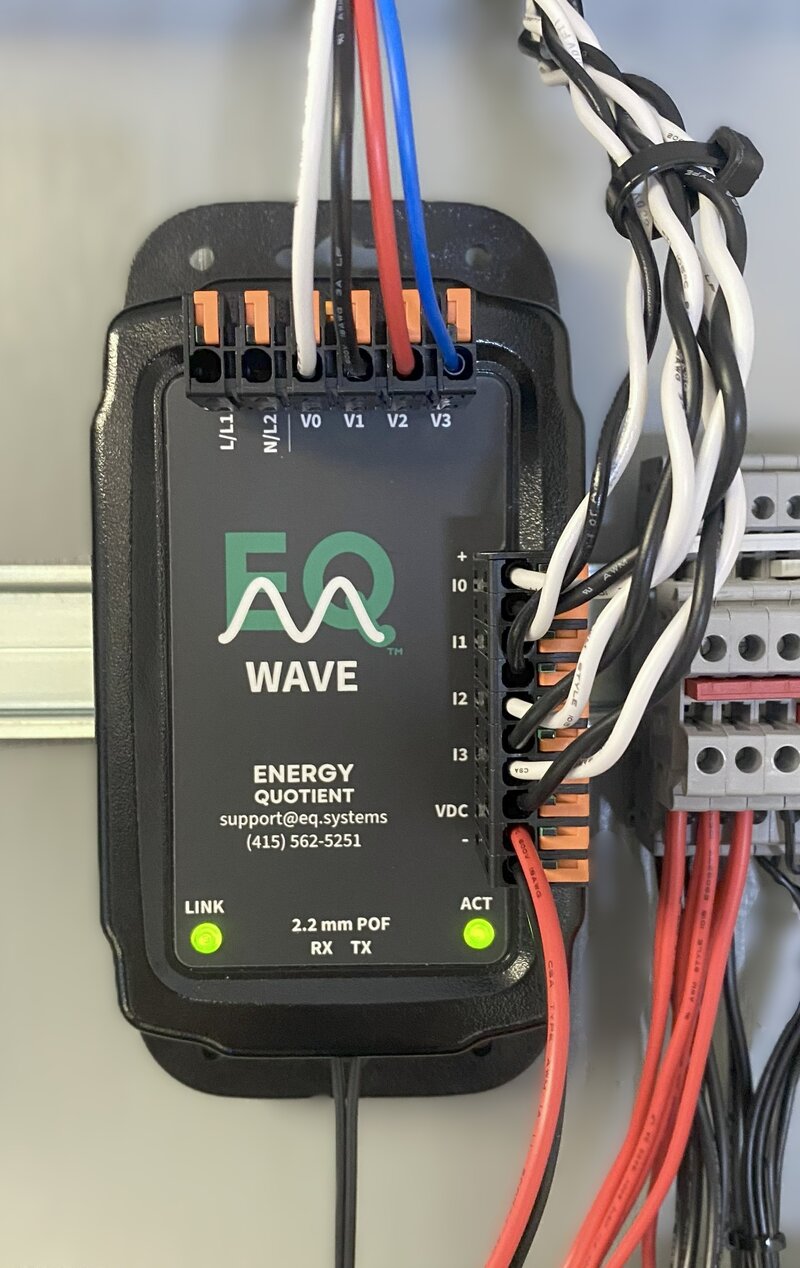 EQ Wave sensor installed in electrical panel with voltage leads, current sensors, and POF fiber connected